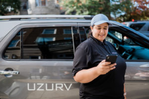 UZURV driver looking at app outside of vehicle