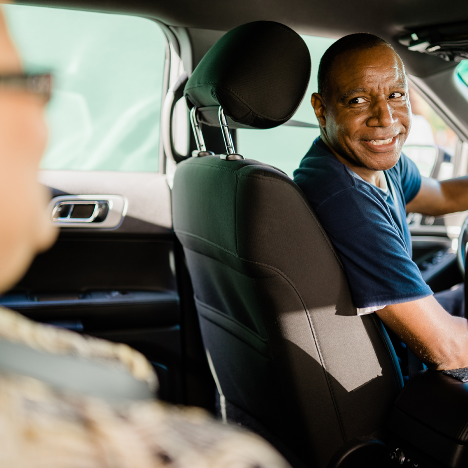 male driver in front seat of vehicle